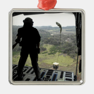 Airman watches a practice bundle fall metal ornament