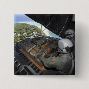 Airmen push out a pallet of donated goods 2 button