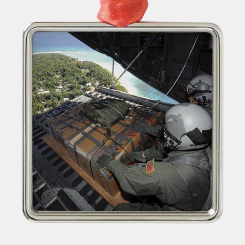 Airmen push out a pallet of donated goods 2 metal ornament