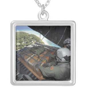 Airmen push out a pallet of donated goods 2 silver plated necklace