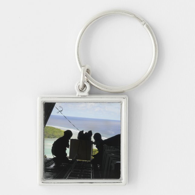 Airmen push out a pallet of donated goods keychain (Front)