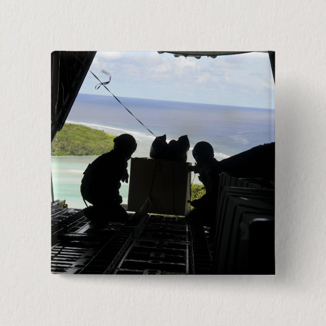 Airmen push out a pallet of donated goods pinback button (Front)