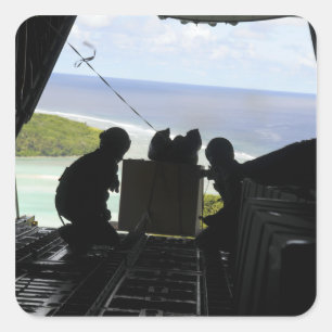Airmen push out a pallet of donated goods square sticker