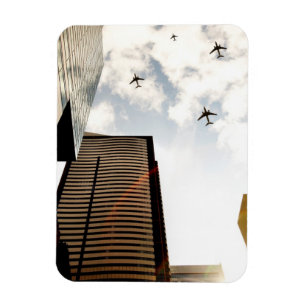 Airplanes flying over buildings magnet
