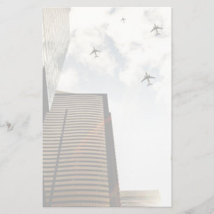 Airplanes flying over buildings stationery