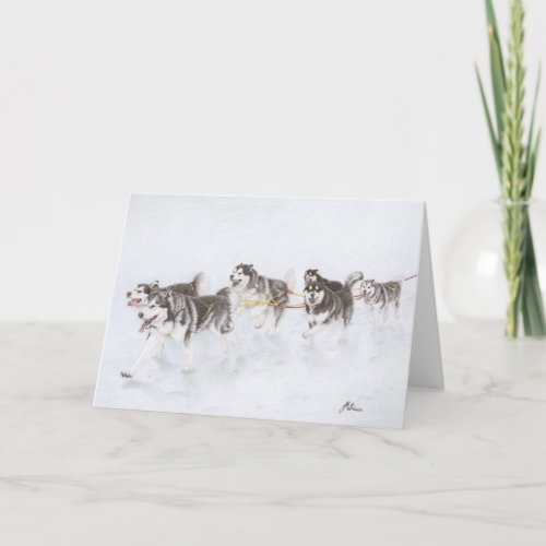 Alaskan Malamute team running through snow Card