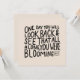 A compact quote design with 'All Along You Were Blooming' in elegant script, representing continuous evolution.