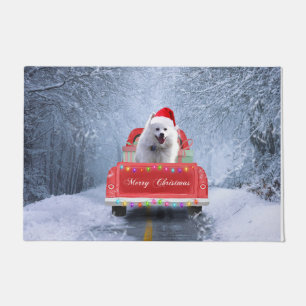 American Eskimo Dog in Snow sitting in Christmas Doormat