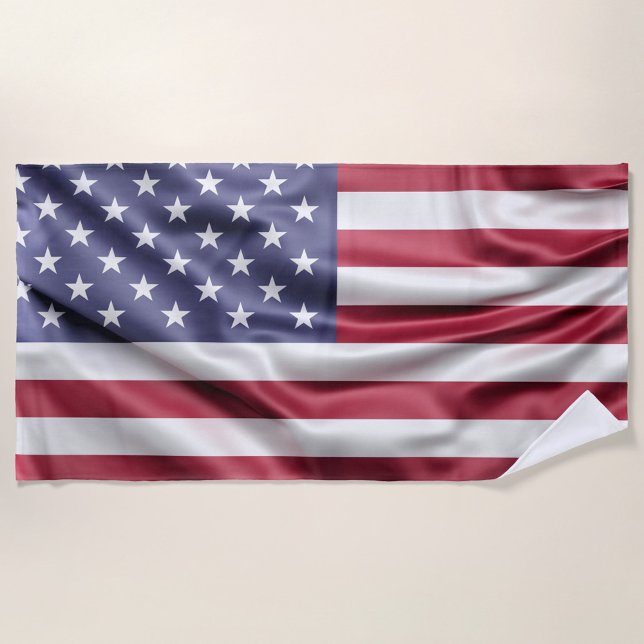 American Flag Beach Towel (A vibrant American flag drapes elegantly against a soft, neutral background.  )