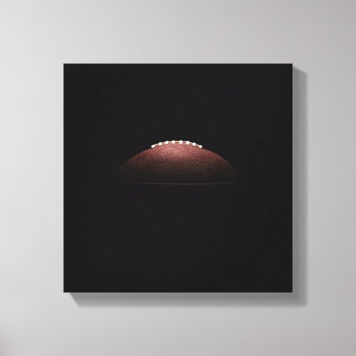 American football ball on black background canvas print