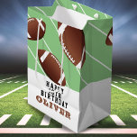 American Football Balls Fun Kids Haqppy Birthday  Medium Gift Bag<br><div class="desc">American Football Balls Fun Kids Happy Birthday Medium Gift Bag. Football balls in different sizes and green background with stripes. Personalize the gift bag with your name and make a great birthday bag for a football fan.</div>