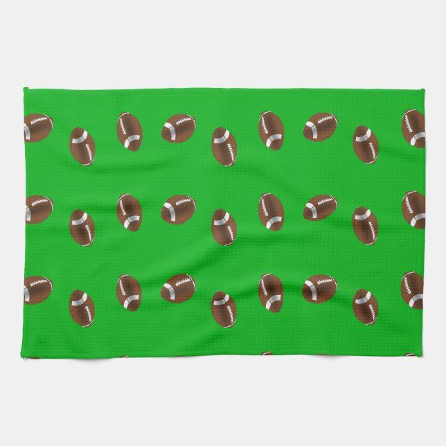 American football balls on green kitchen towel (Horizontal)