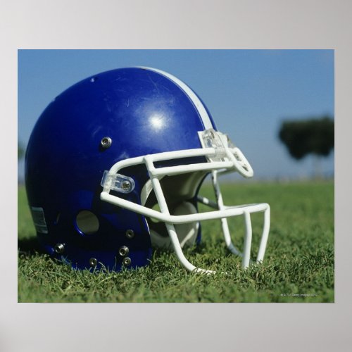 American football helmet in grassclose_up poster
