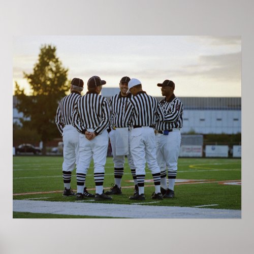 American football referees talking in field poster