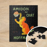 Amidon Au Chat | Leonetto Cappiello Jigsaw Puzzle<br><div class="desc">Amidon Au Chat (1903) | Leonetto Cappiello’s vintage advertising poster Amidon Au Chat for Hoffman features a whimsical orange cat playfully interacting with a box of starch, set against a striking black background. The vibrant orange of the cat and the bold typography create a high-contrast design that is both eye-catching...</div>