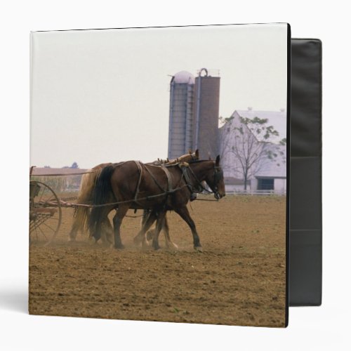 Amish farmer using a horse drawn seed planter binder