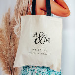 Ampersand Monogram Wedding Welcome Tote Bag<br><div class="desc">Simple and chic wedding welcome tote bags feature your initials worked into a monogram design,  joined by a decorative script ampersand. Personalize with your wedding date and location beneath in timeless serif lettering. Perfect as favors or hotel gift bags.</div>