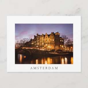Amsterdam canal houses at dusk white postcard