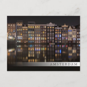 Amsterdam houses with colorful lights in the night postcard