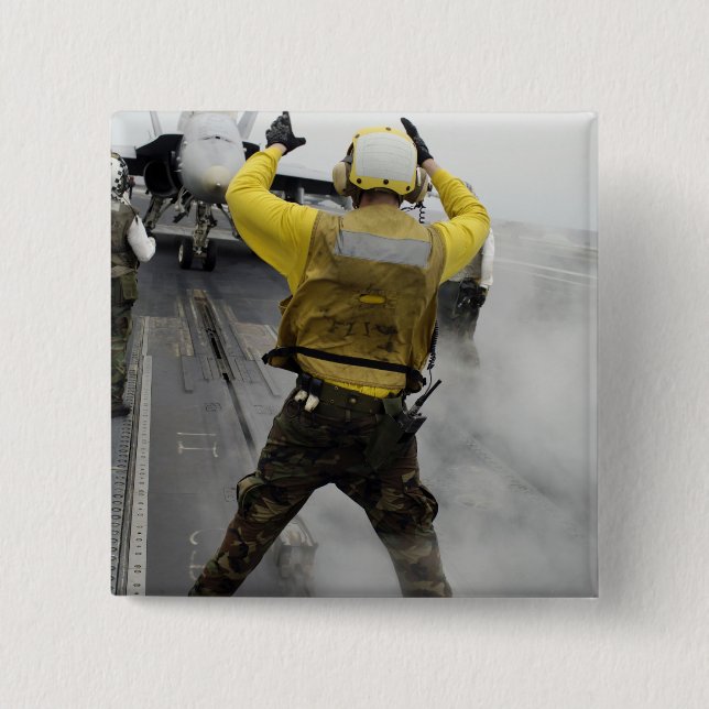 An aircraft director signals a F/A-18C Hornet Button (Front)