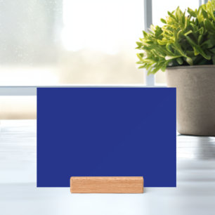 an airplane flying in the sky with a blue backgrou holder