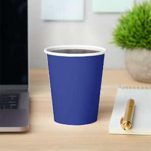 an airplane flying in the sky with a blue backgrou paper cups