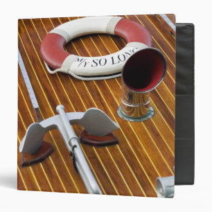 An Anchor And A Life-Buoy On A Wooden Boat Binder
