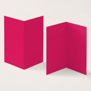 An array of red and pink flowers with lush green l