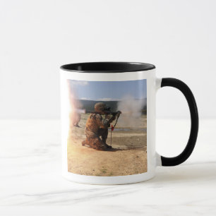 An assaultman fires a Rocket Propelled Grenade Mug