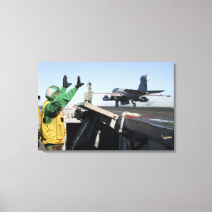 An EA-6B Prowler launches from the flight deck Canvas Print