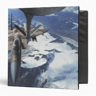 An F-15C Eagle aircraft sits behind a KC-135R 3 Ring Binder