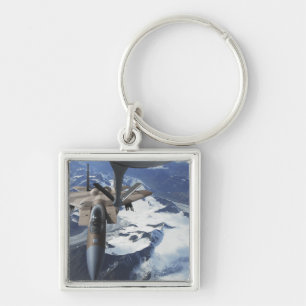 An F-15C Eagle aircraft sits behind a KC-135R Keychain