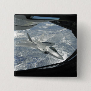 An F-22 Raptor banks away from a KC-135 Button