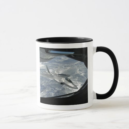 An F_22 Raptor banks away from a KC_135 Mug