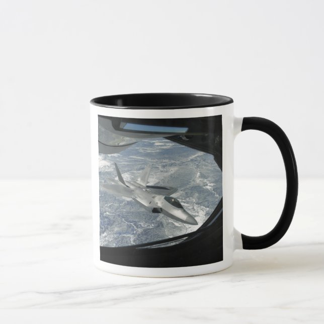 An F-22 Raptor banks away from a KC-135 Mug (Right)