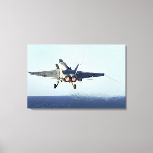 An FA_18C Hornet launches from the flight deck Canvas Print