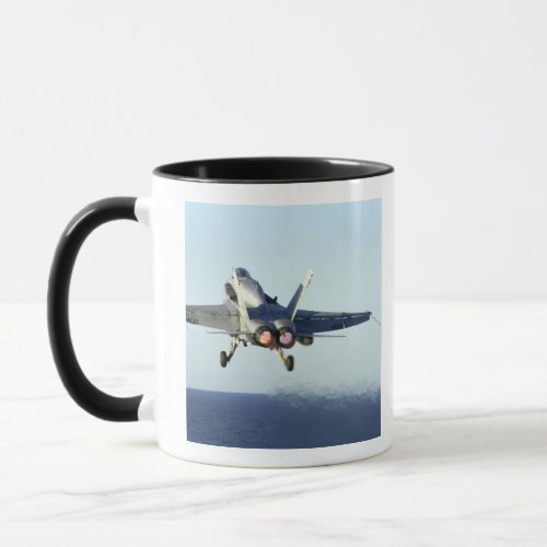 An FA_18C Hornet launches from the flight deck Mug