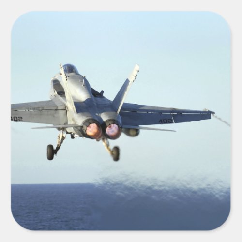 An FA_18C Hornet launches from the flight deck Square Sticker