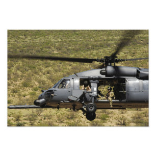 An HH-60 Pave Hawk flies over the desert Photo Print