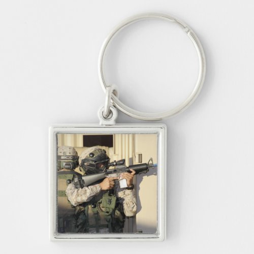 An infantry scout aims his weapon keychain