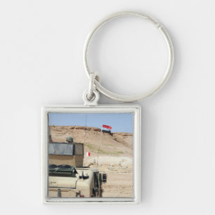 An instructor watches as an Iraqi army soldier Keychain