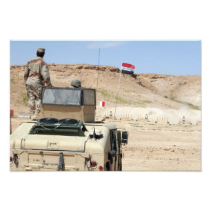 An instructor watches as an Iraqi army soldier Photo Print
