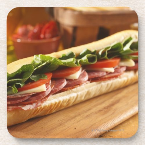 An Italian sub sandwich with 2 Coaster