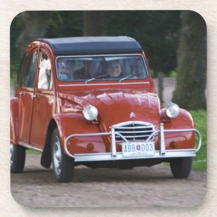 An old red Citroen 2CV car with a smiling woman Beverage Coaster