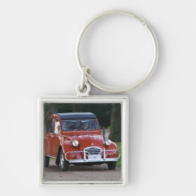 An old red Citroen 2CV car with a smiling woman Keychain (Front)