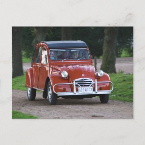 An old red Citroen 2CV car with a smiling woman Postcard