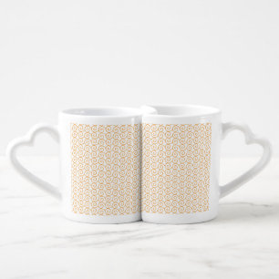 an orange and white background with swirls coffee mug set