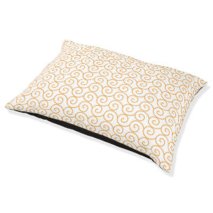 an orange and white background with swirls pet bed