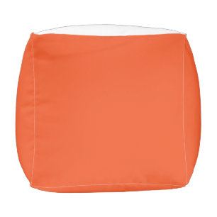 an orange background with a black border pouf