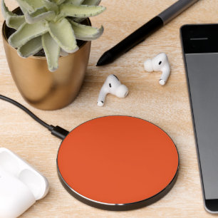 an orange background with a black border wireless charger